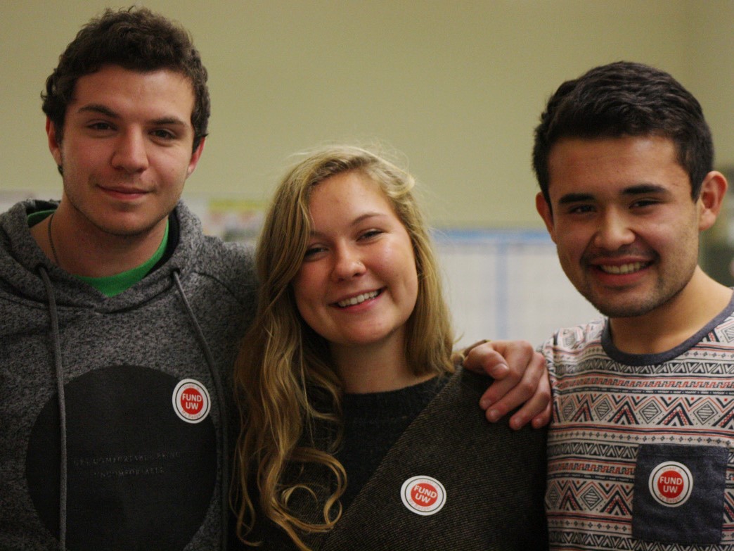 A group of volunteers smile at the camera.